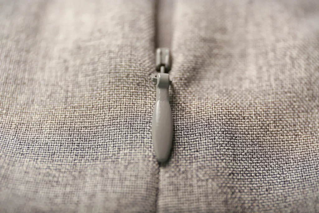 Zoom em um zíper invisível em uma roupa cinza de linho