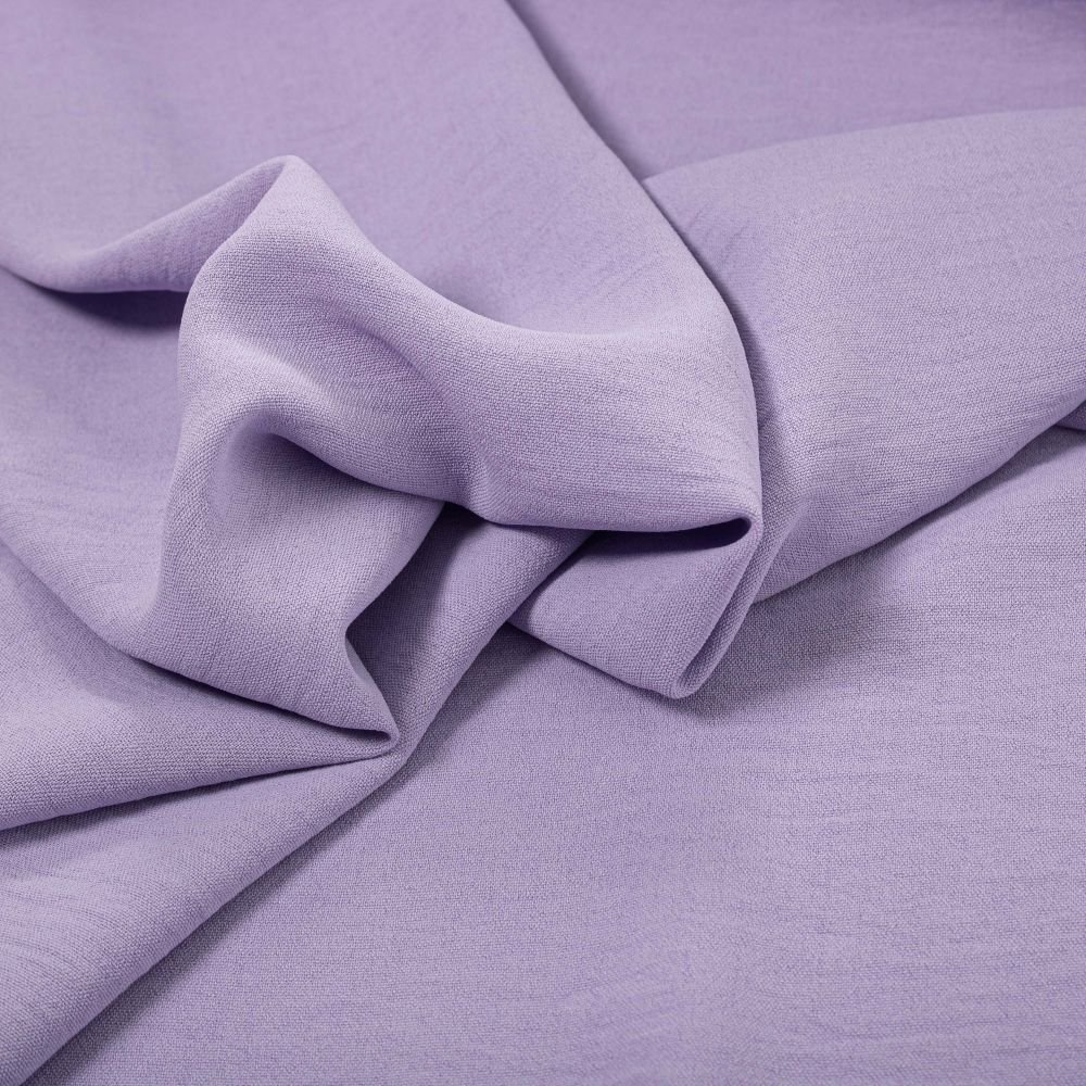 The image showcases a close-up view of lilac crepe fabric.