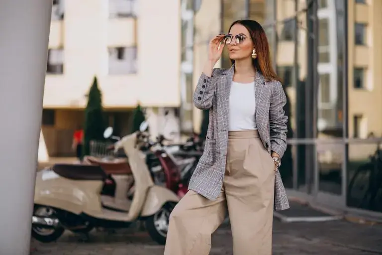 Woman in elegant fashion style outfit, plaid print pieces and pleated linen pants.