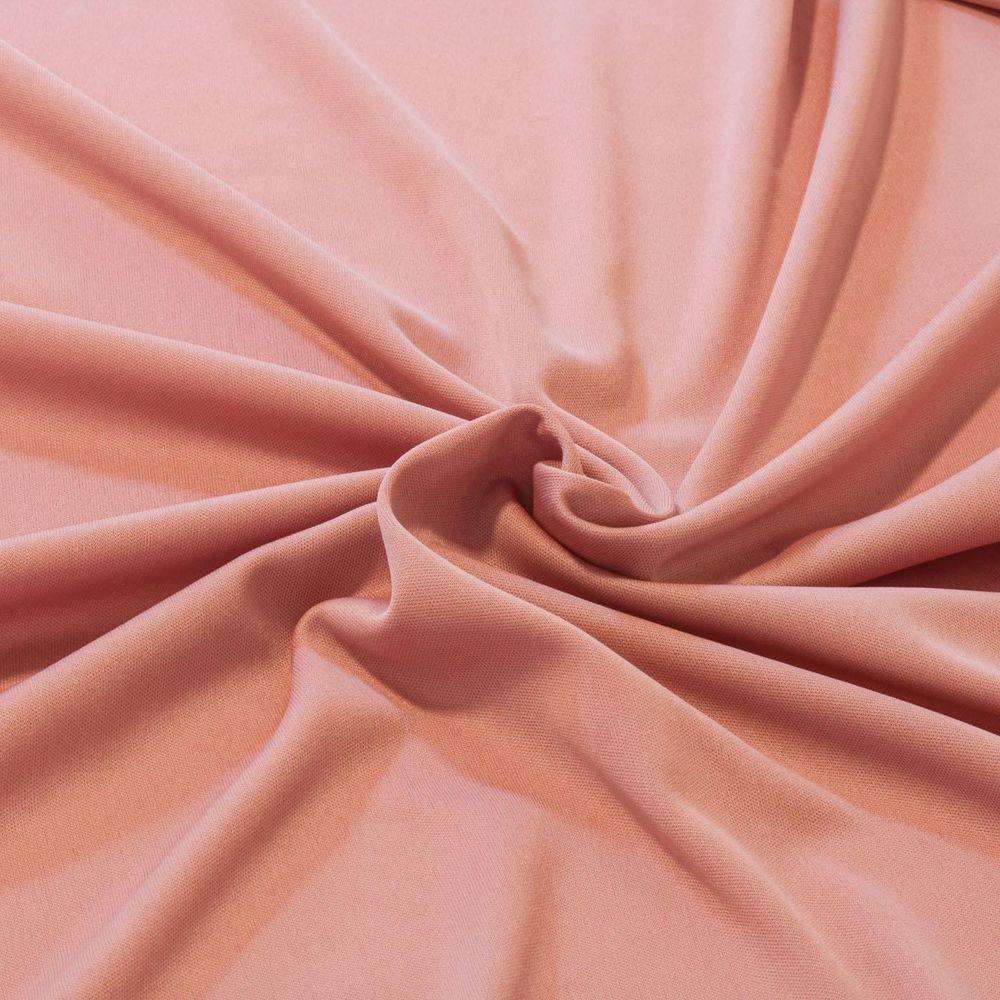 A swatch of light pink helanca fabric. 