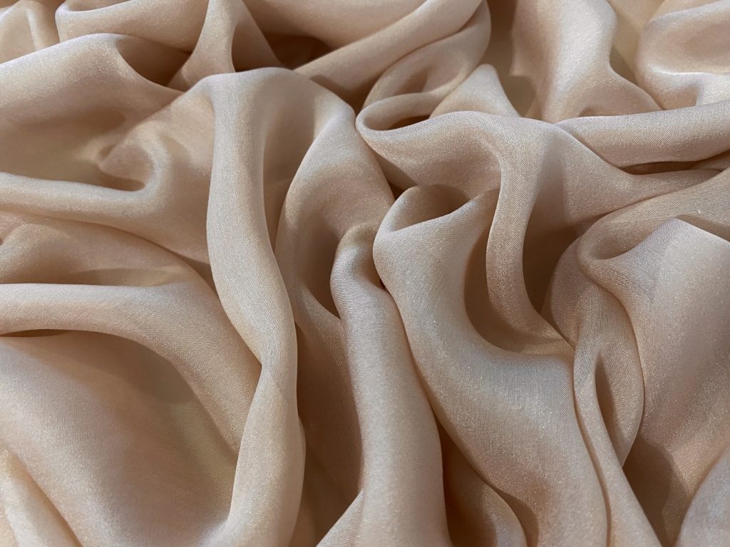 Muslin fabric swatch showcasing its delicate texture.