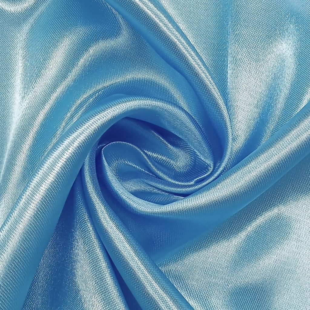 Light-blue satin fabric showcasing its intense shine and luxurious appeal.