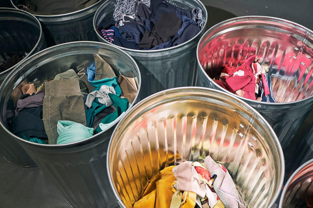 latas de basura conteniendo kilos de telas de diversos colores