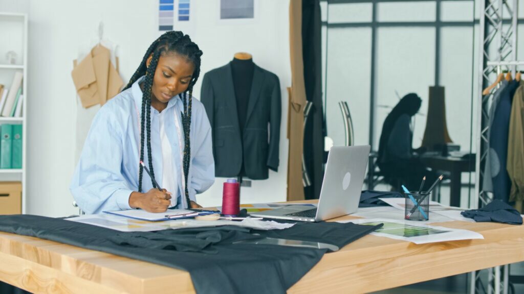 Image shows a woman checking if the sustainable consumption and production standards are correctly applied to the clothing company.