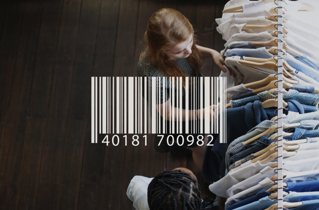 The picture shows two young women checking out some clothes and there's a barcode overlay representing the GTIN 