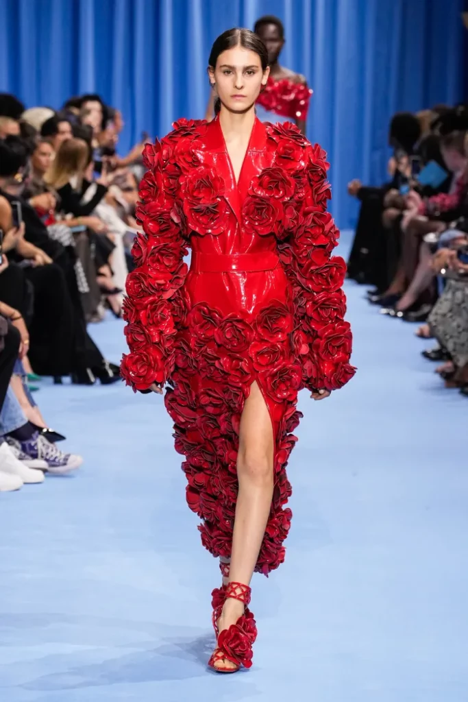 Spring/Summer trends: Model on the catwalk wearing an outfit studded with red roses.