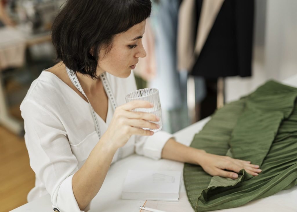 Woman working and checking the composition of a piece of clothing, representing one of the Fashion Revolution concerns