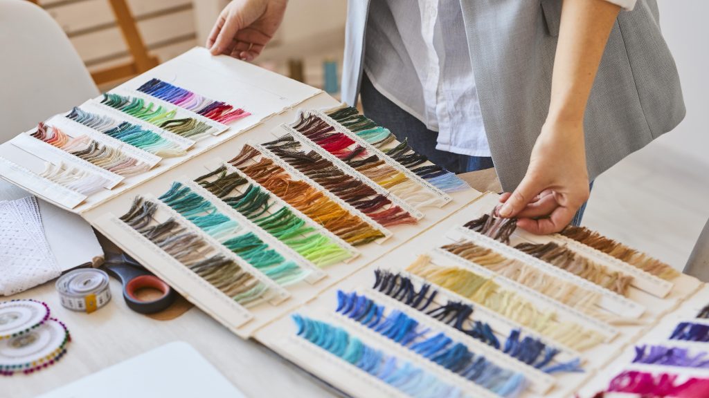 A person checking out the color chart of a clothing collection