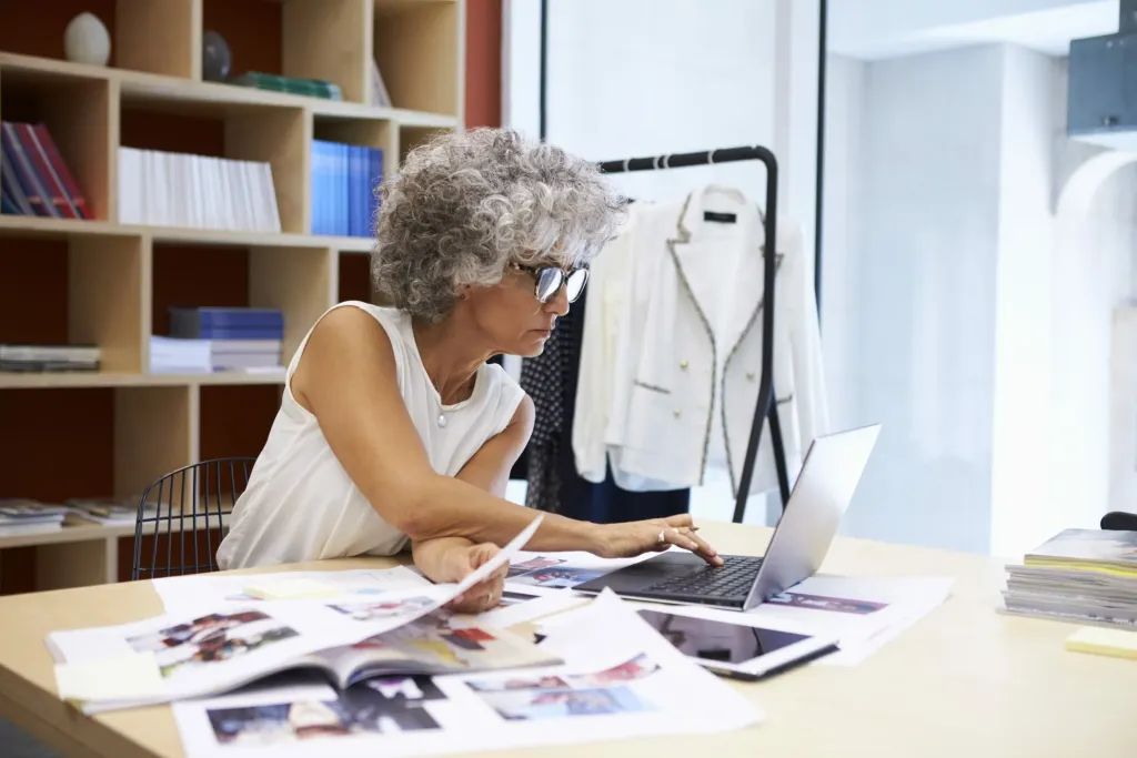 Female fashion designer researching fashion trends