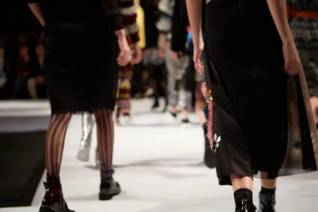 Fashion week schedule: Models walking down a runway 