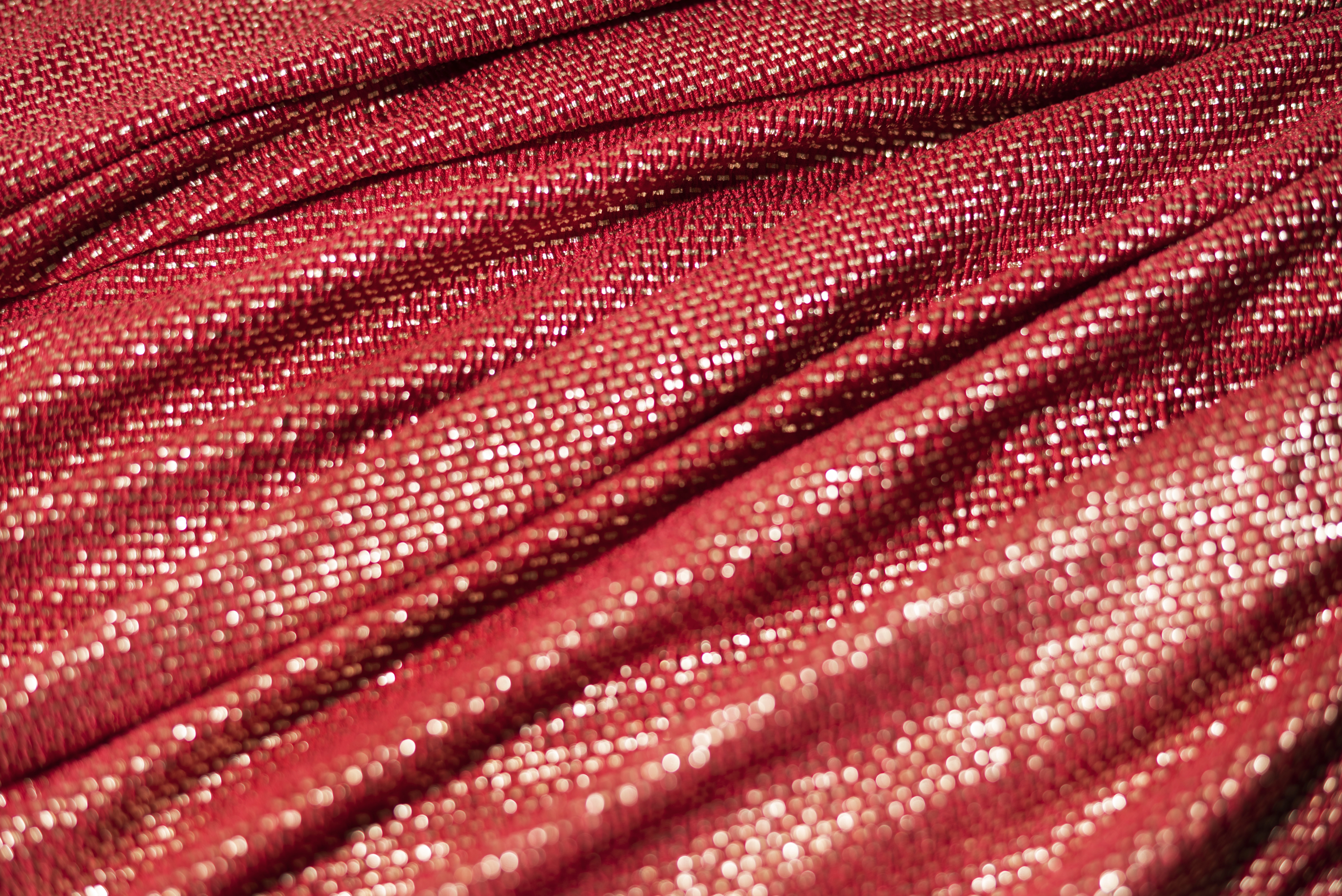 Tecido vermelho com fios de lurex em dourado.