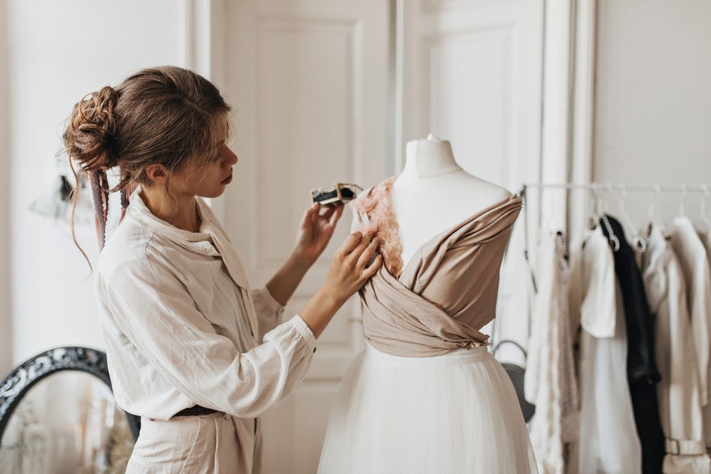 Modeling techniques: Woman creating a pattern of clothing using the three-dimensional method, also known as draping or moulage.