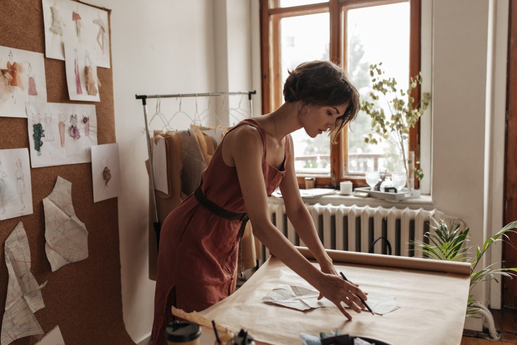 Modeling techniques: Woman using the flat pattern method to create a piece of garment.