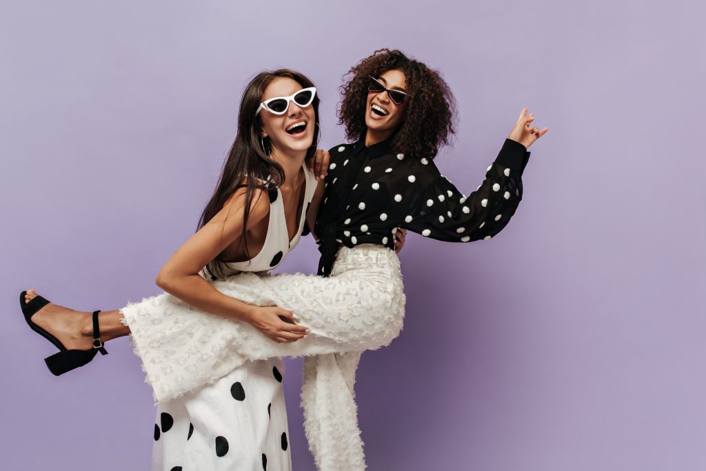 Fashion future: Two women posing for a photo conveying a feeling of well-being.