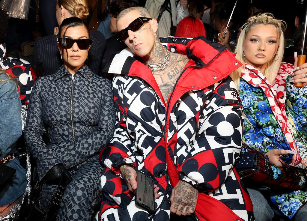 Phygital fashion: Celebrities in the front row of a fashion show of a famous brand.