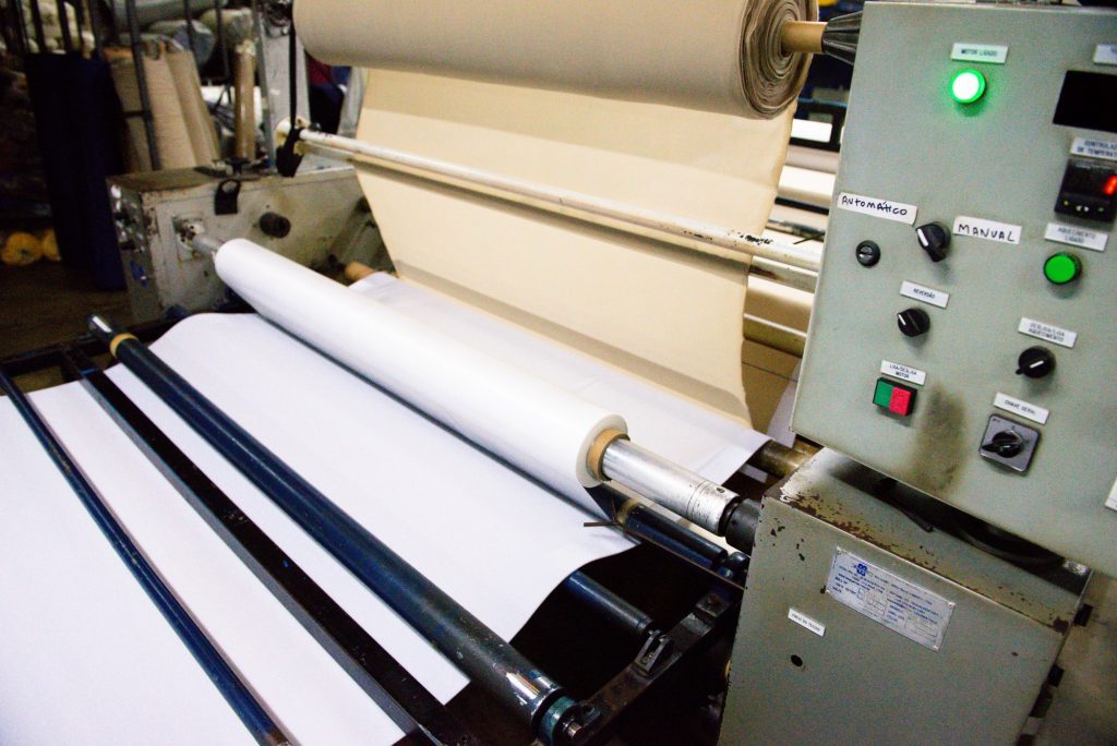Image of a textile machine creating a bonded fabric.
