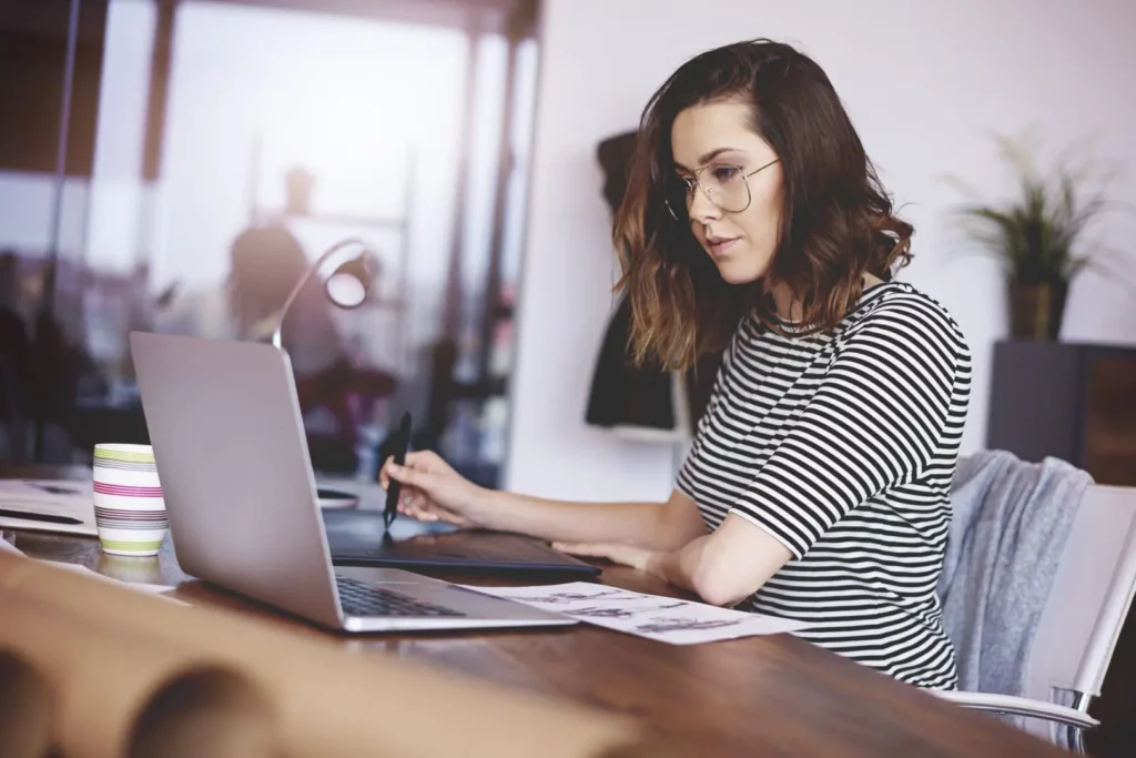 Female professional checking out some garment digital solutions.