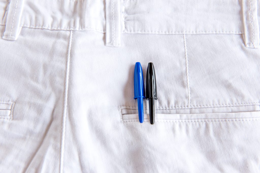 The picture shows a white pair of jeans with sewing darts in detail.