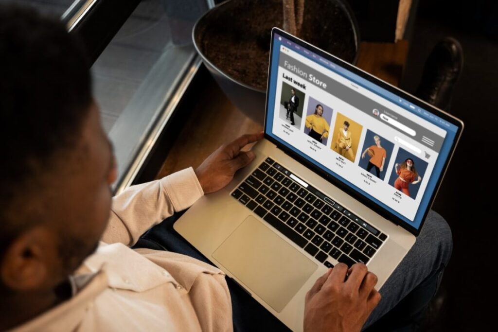 Online clothing business: Man browsing a fashion e-commerce platform.