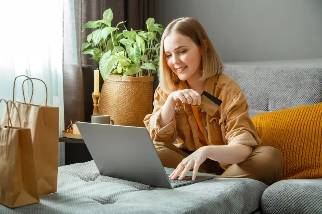 Online lingerie store: Woman making purchases on an e-commerce platform using laptop.