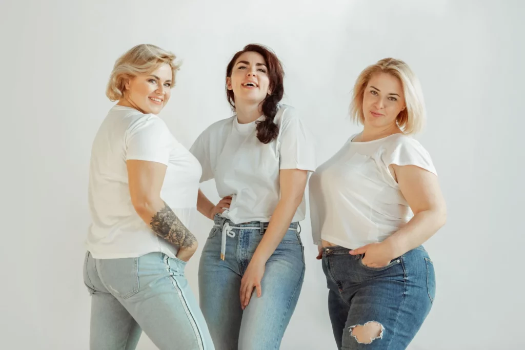 Women with diverse bodies wearing pieces created using a plus-size sizing chart.