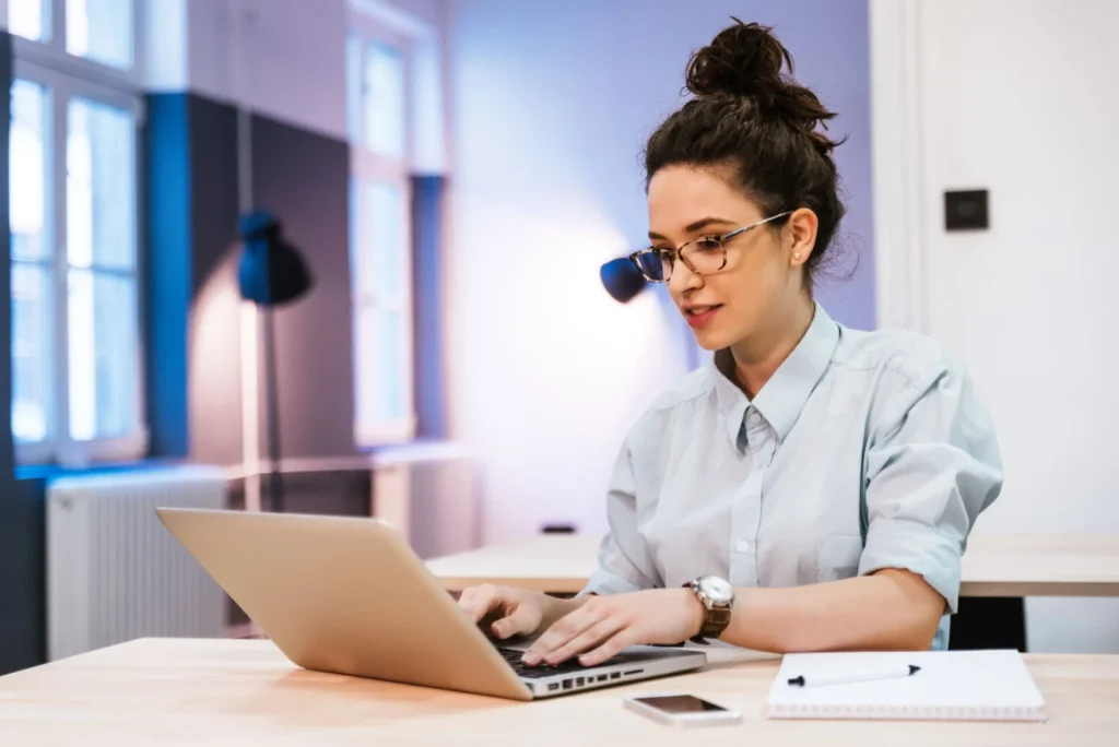 Woman using the computer while having an online fashion design experience.