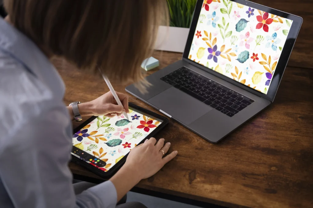 A woman creating a digital floral pattern design for print-on-demand clothing
