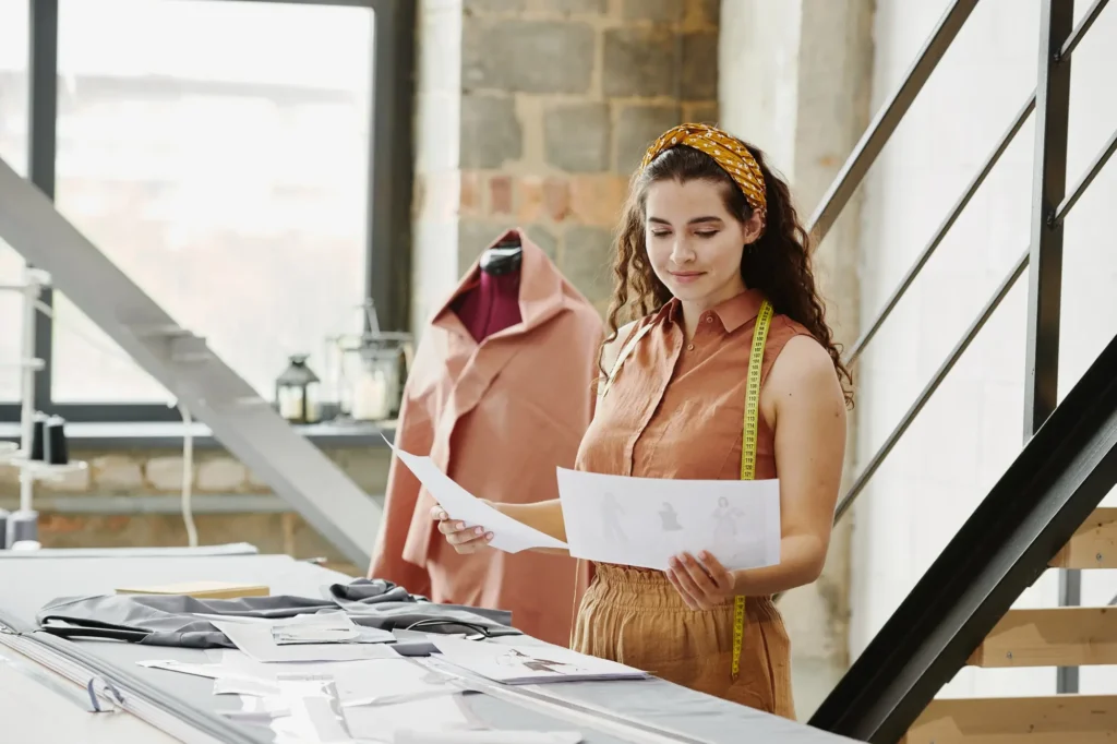 A fashion designer selecting the best pieces of clothing for a collection.