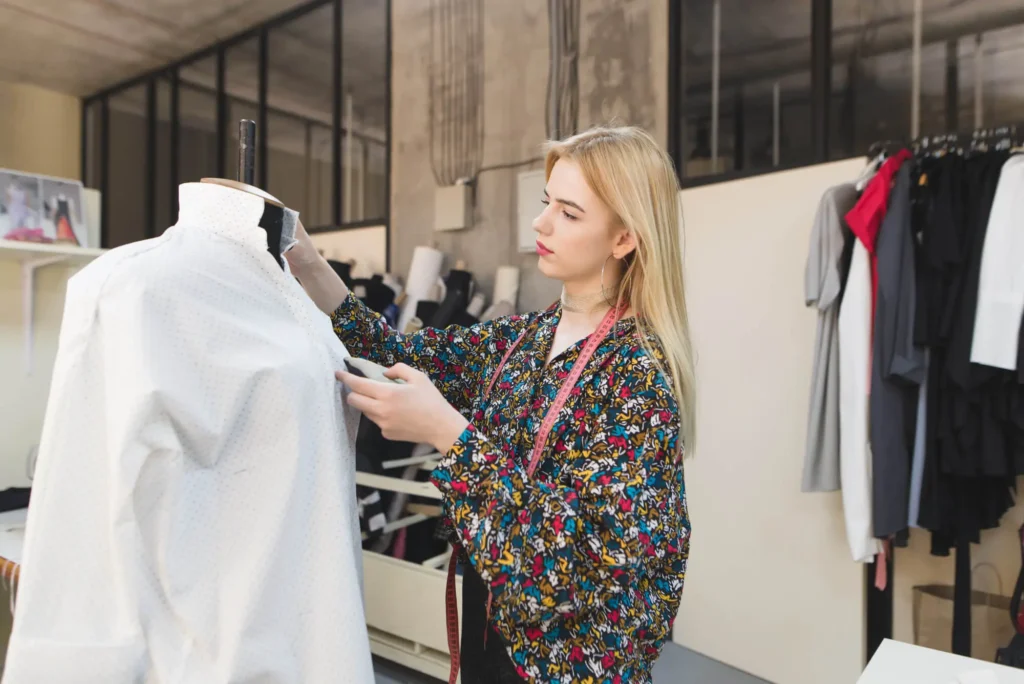 A woman working on the quality stage of clothing management.