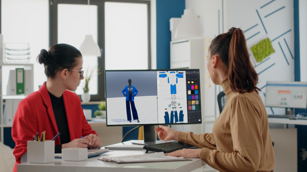 Two fashion professionals working together on clothing pattern design.