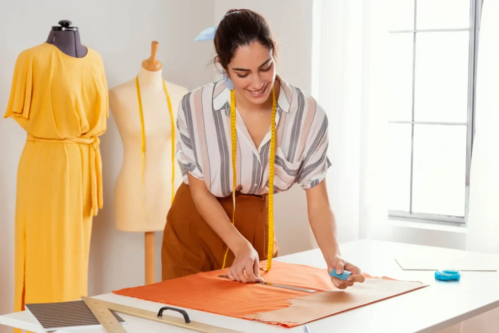 A fashion designer drafting a clothing pattern design.