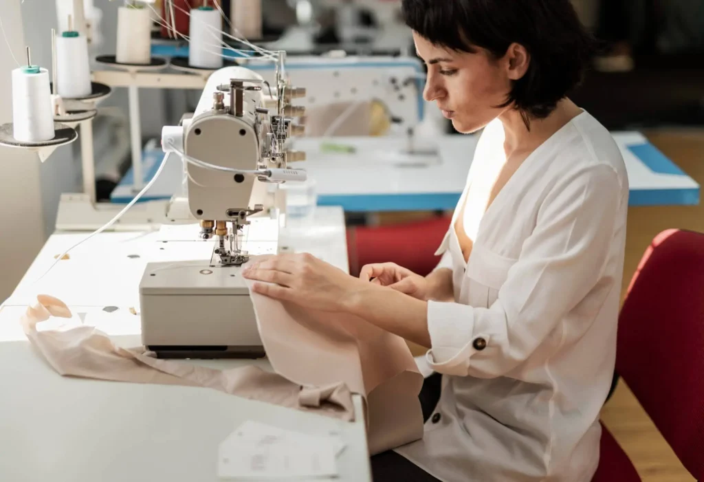 A seamstress working as part of a production guild.