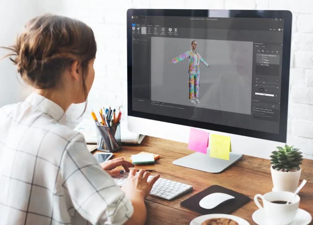 A fashion designer using 3D design software to develop her creations.