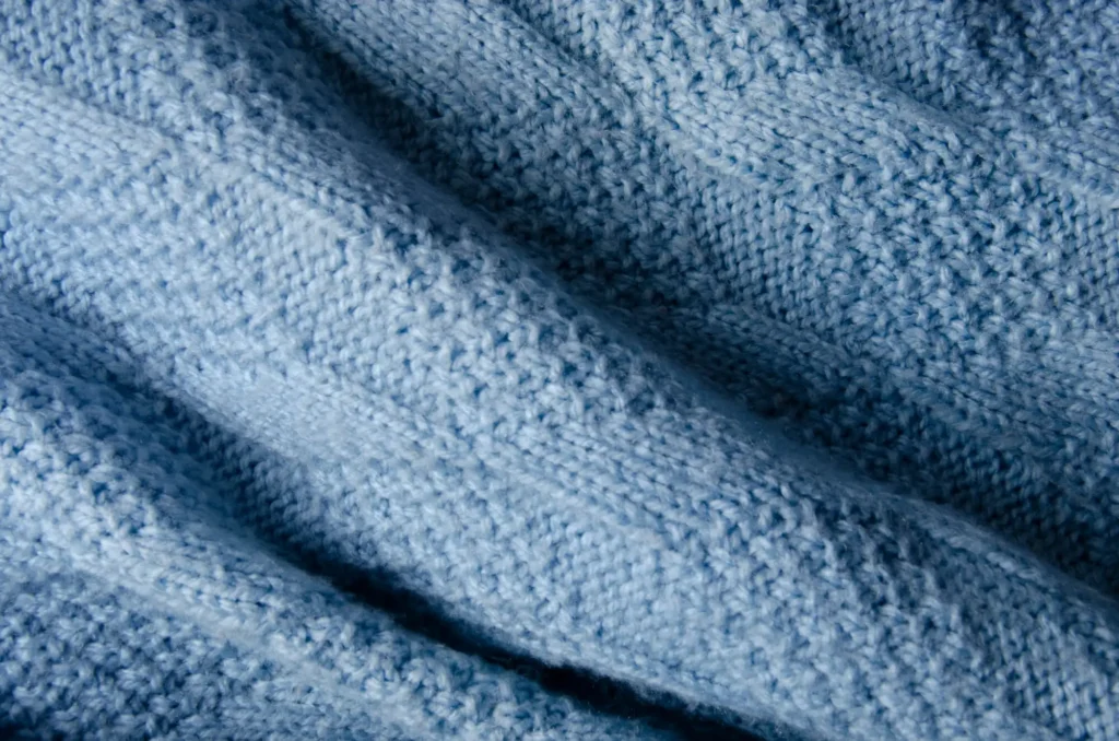 A close-up of a fabric texture in blue wool.