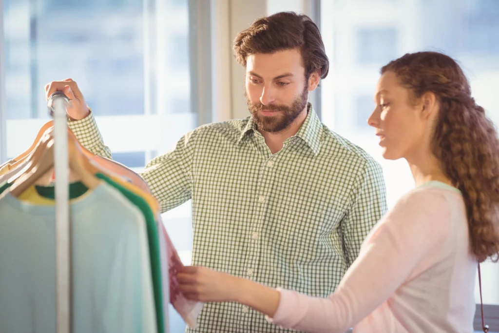 People examining clothing items with product warranties 