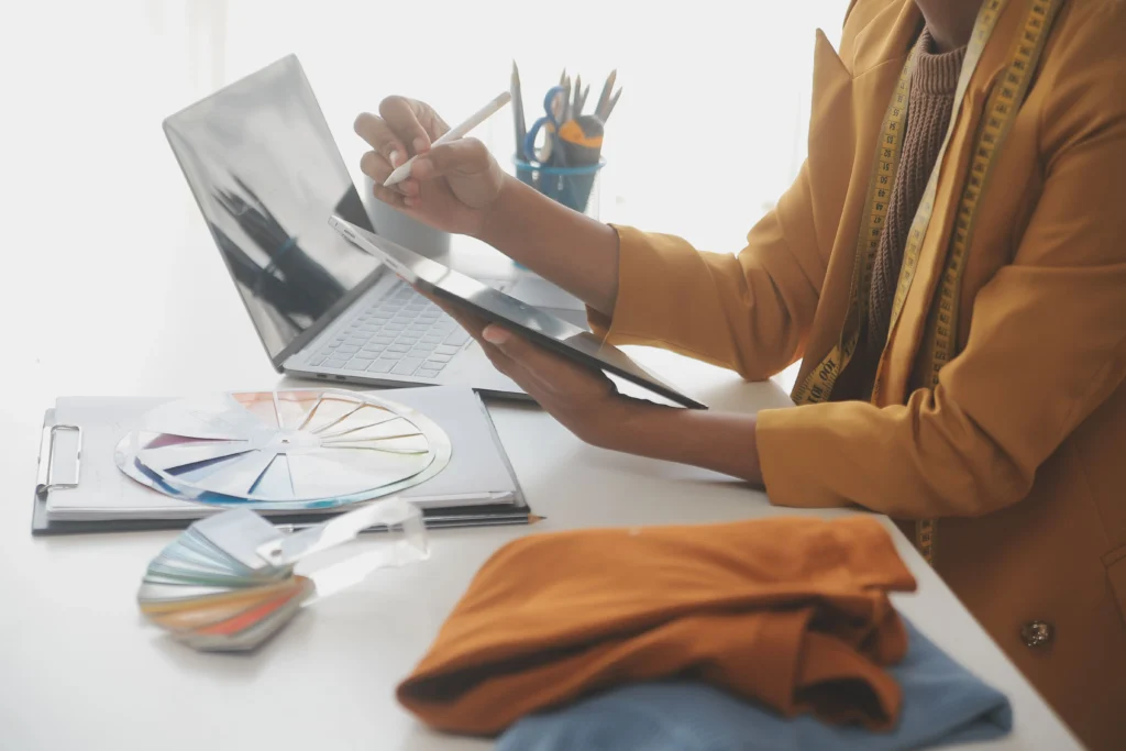 Woman creating a shirt pattern on a computer 