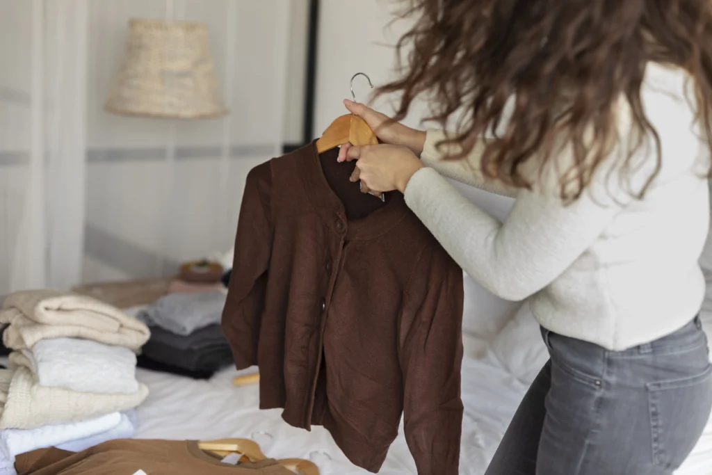 Woman sorting slow fashion clothing 