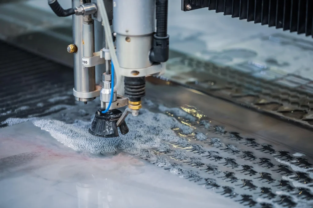 Waterjet cutting machine uses water jets to cut the material.