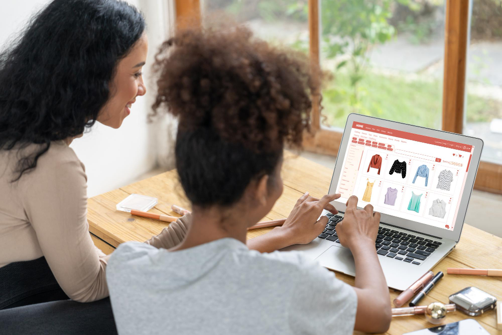 Two women experiencing an online shopping experience personalized to their consumer profiles.