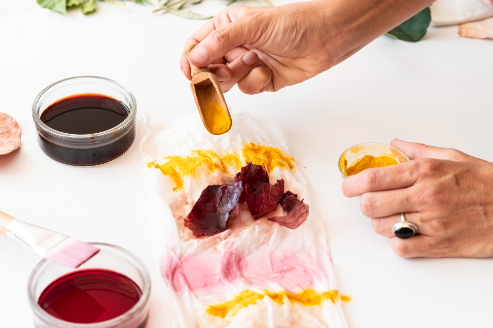 A person using vibrant colors to create a print through natural dyeing.