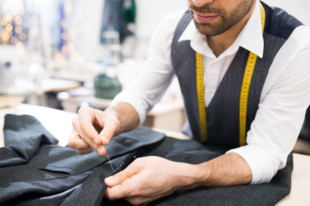 A tailor working on a blazer for tailored clothing.