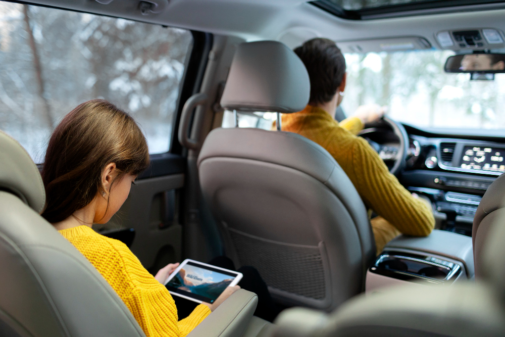 Emerging auto trends: Two people inside a car with a high-tech interior.