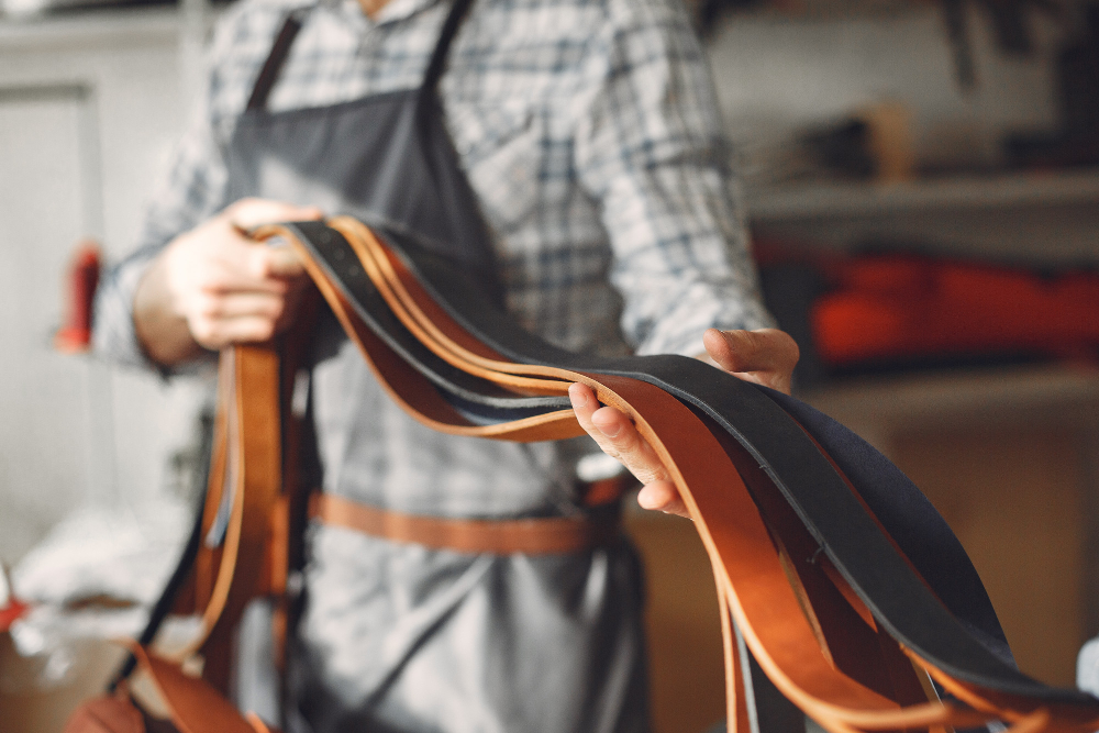 Leather cutting tools: a worker producing belts.