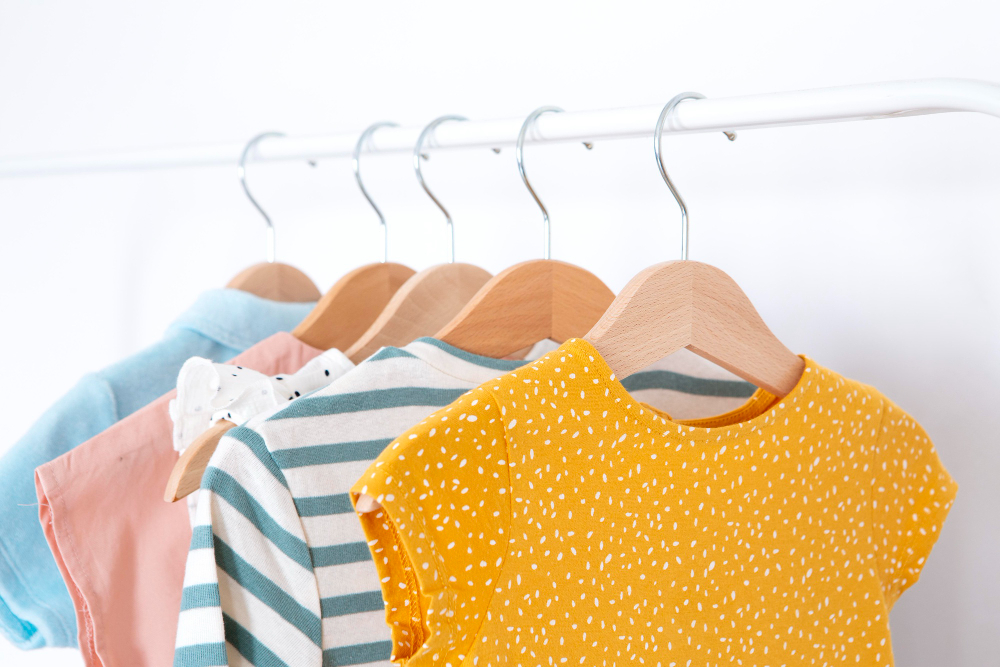 Kids patterns: colorful children's clothing pieces hanging on hangers.