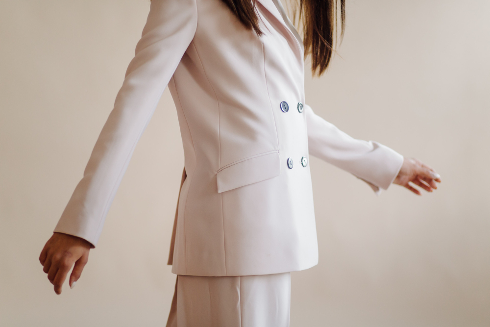 Types of coats: a woman wearing a white tailored suit.