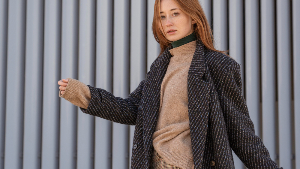 Types of coats: a woman wearing a turtleneck and a gray coat.