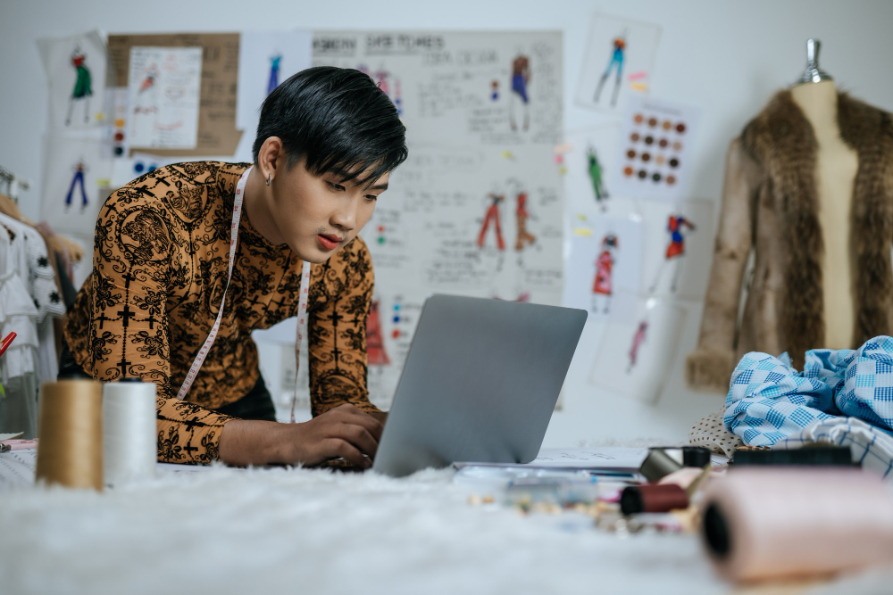 Fashion creation: a fashion designer working on a laptop.