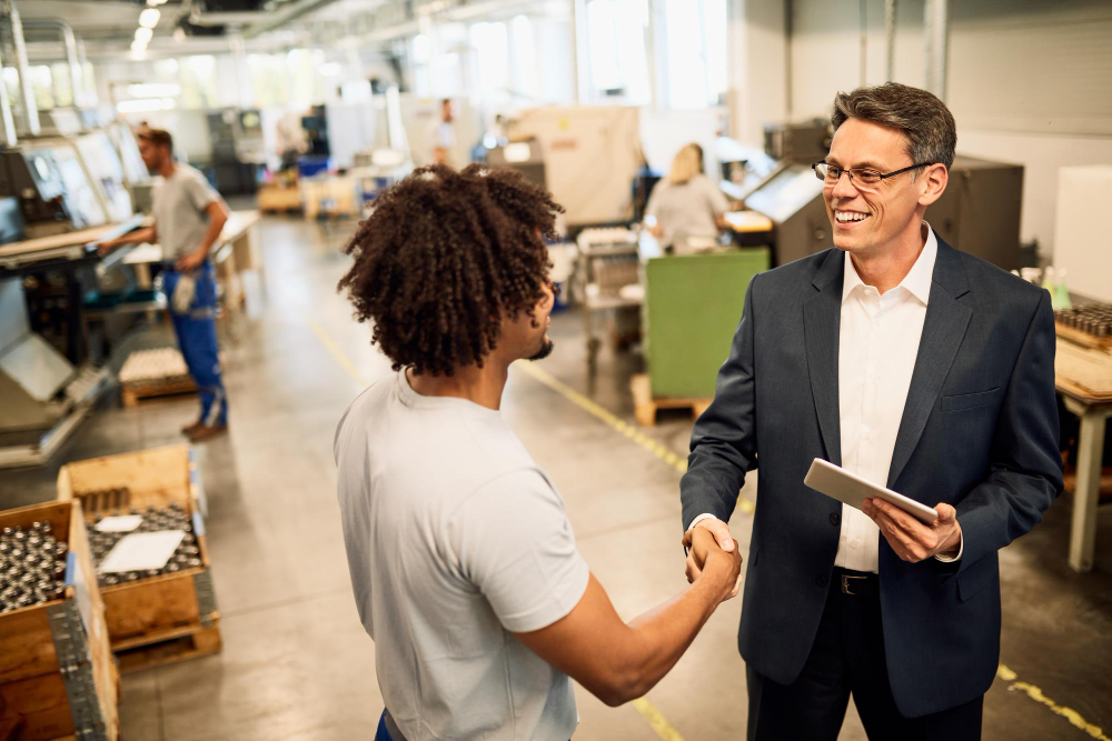 Incentives in industry: two men shaking hands, closing a deal.