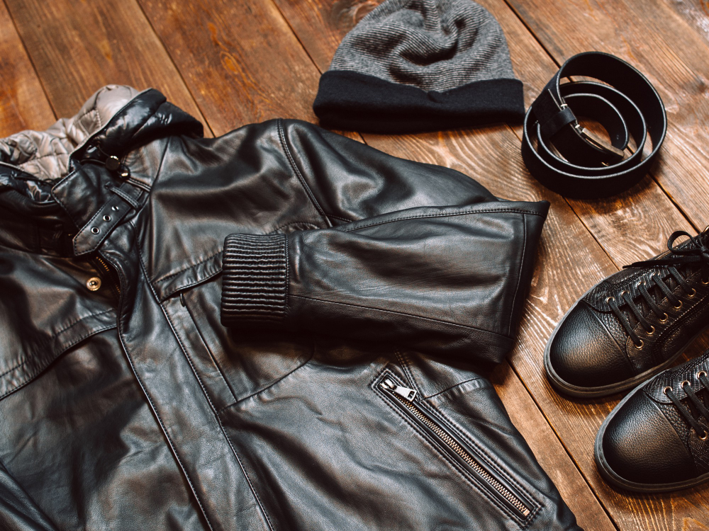 Leather cut: pieces of leather on a table, including a jacket, a shoe, and a belt.