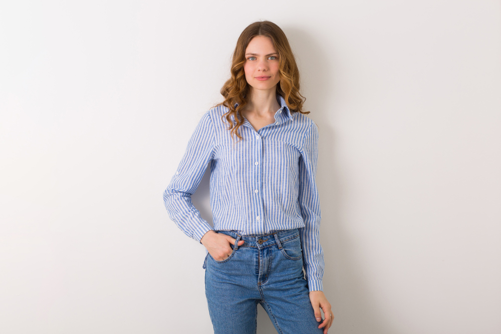 Versatile clothing: a woman in a blue shirt against a light background.